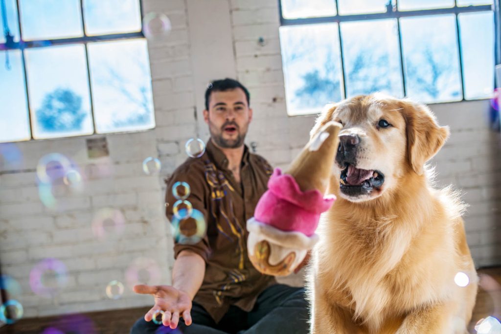 a man and his golden posing for a pet photography session in Lux Summit Studio