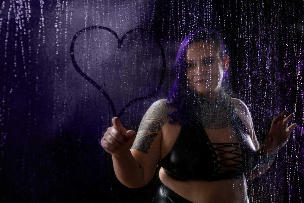 a boudoir photography of a curvy purple hair lady